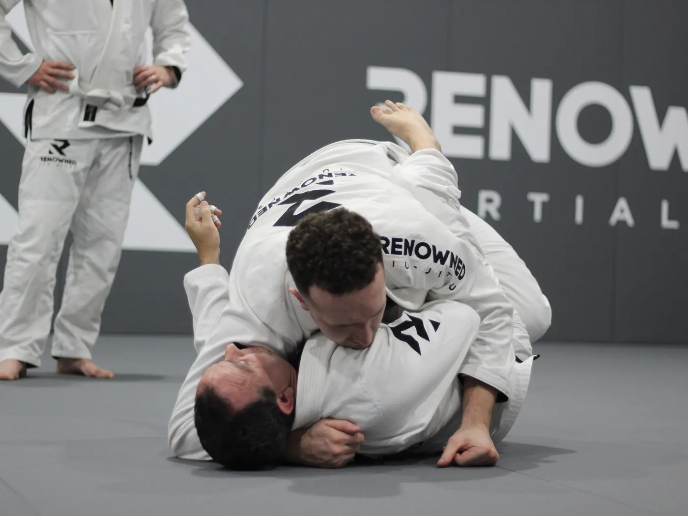 A coach guiding a student through a position, close up